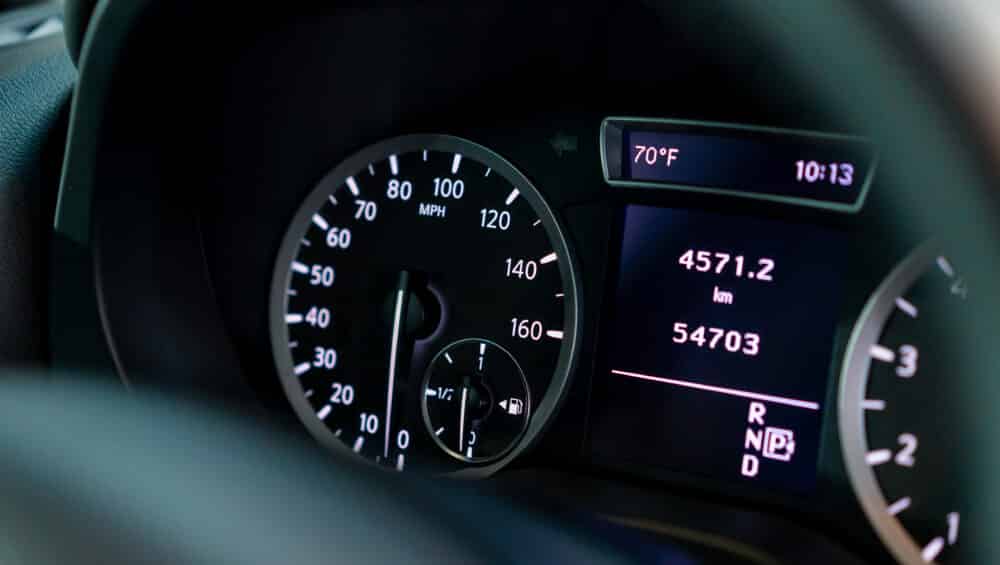 Close-up of the odometer and dashboard of a luxury car with a black interior after detailing and washing at a car service