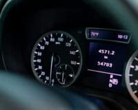 Close-up of the odometer and dashboard of a luxury car with a black interior after detailing and washing at a car service